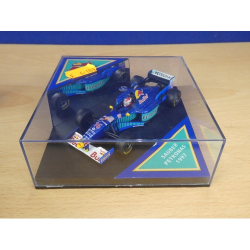 137 - A cased Red Bull Sauber Petronas 1997 Formula One cars, racing driver Johnny Herbert and a cased Ony... 