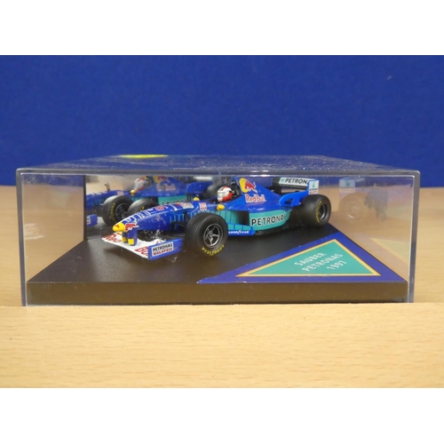 138 - A cased Red Bull Sauber Petronas 1997 Formula One cars, racing driver Johnny Herbert and a cased Ony... 