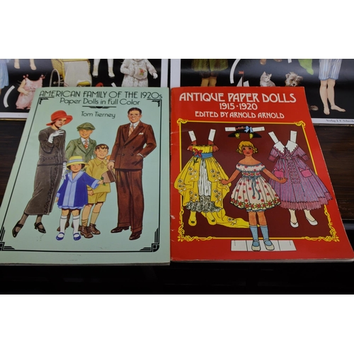 346 - A lot of 2 antique paper doll books and 2 old dressable doll posters.