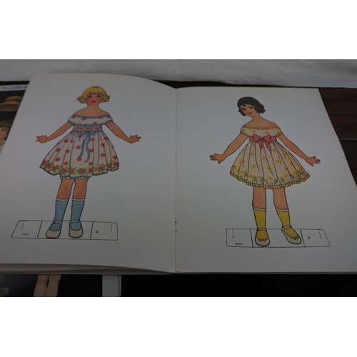 346 - A lot of 2 antique paper doll books and 2 old dressable doll posters.