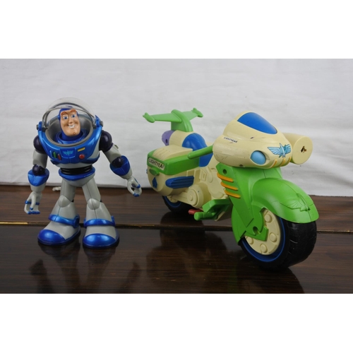 356 - A working Buzz Lightyear motorbike, poster and other toys.