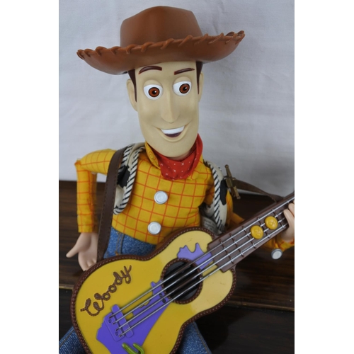 357 - An unboxed (working) Strummin, Singing and Whistling Woody Figure and another.