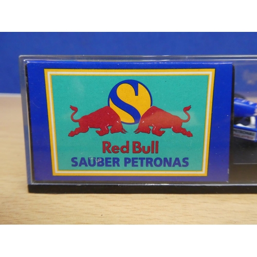 333 - A cased Red Bull Sauber Petronas 1997 Formula One cars, racing driver Nicola Larini.