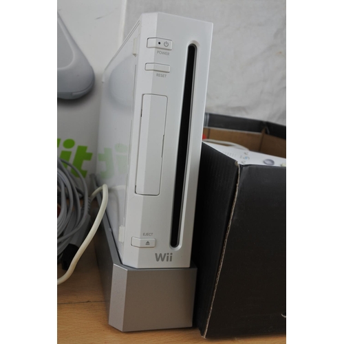 74 - A Nintendo Wii console, games, controllers and more.