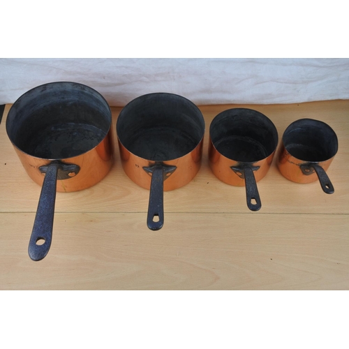 75 - A set of four antique copper saucepans.