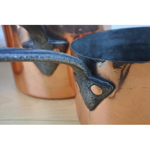 75 - A set of four antique copper saucepans.