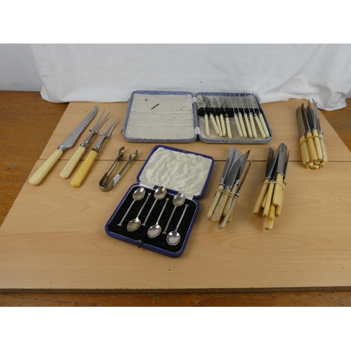 104 - Two boxed vintage cutlery sets and an assorted lot of vintage cutlery, carving set and more.