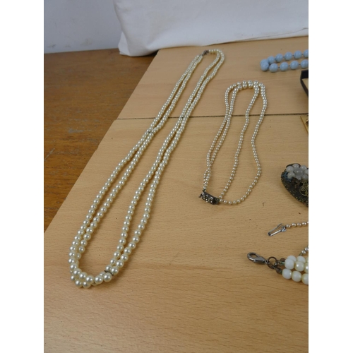 110 - A collection of vintage pearls and necklaces in an antique jewellery box.