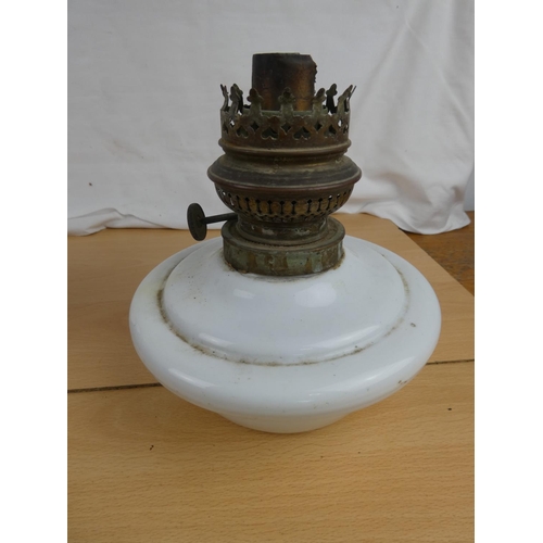 117 - An antique ceramic oil lamp font and an old metal jug.