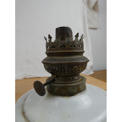 117 - An antique ceramic oil lamp font and an old metal jug.