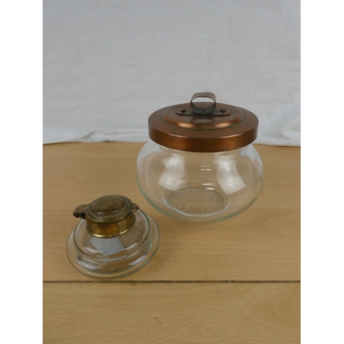 124 - A brass topped inkwell and a copper lidded storage jar.