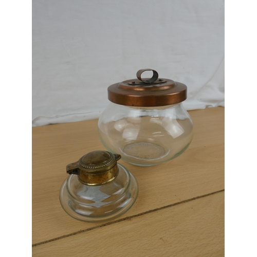 124 - A brass topped inkwell and a copper lidded storage jar.