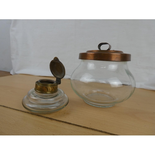 124 - A brass topped inkwell and a copper lidded storage jar.