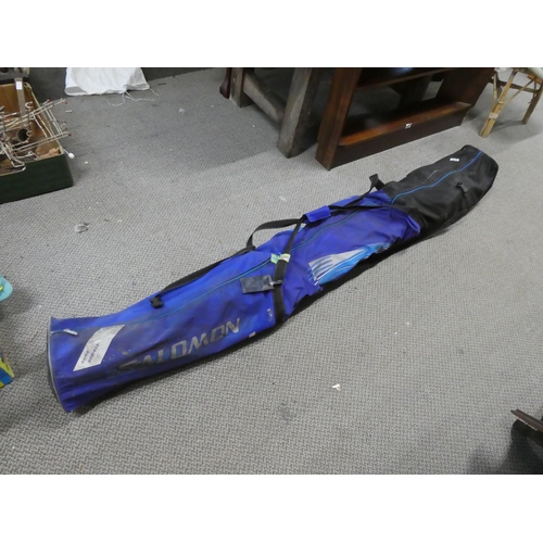 128 - A pair of Salomon snow skis and storage bag. Approx 187cm.