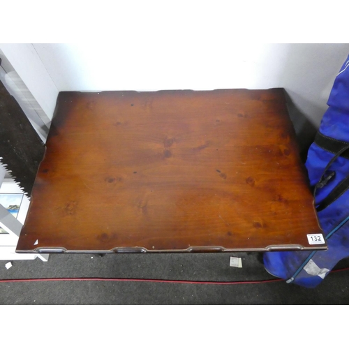 132 - A coffee table on a metal stand. Approx 53x79x55cm.