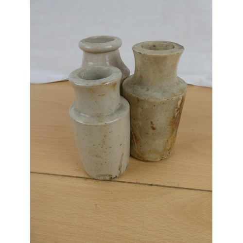 143 - Three antique stoneware bottles.