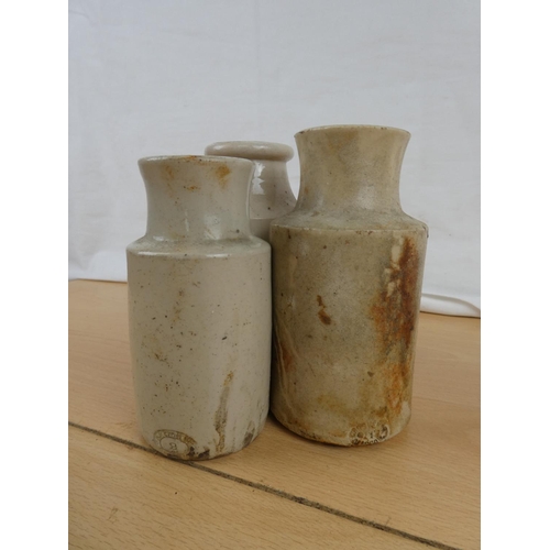 143 - Three antique stoneware bottles.