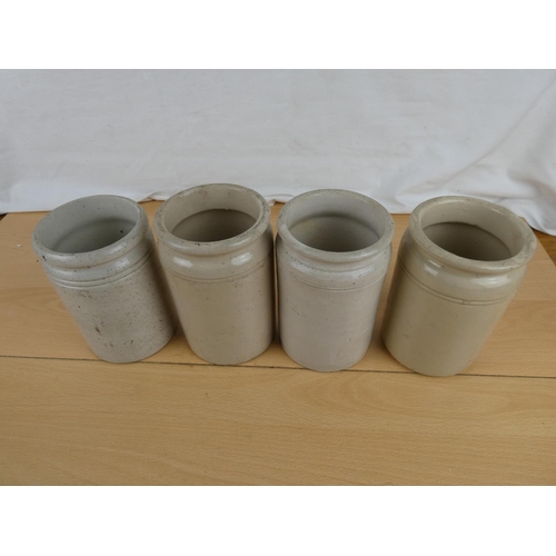 144 - Four antique stoneware jars.