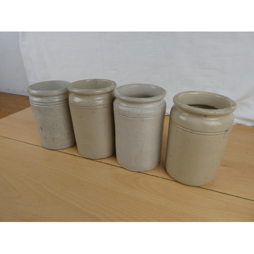 144 - Four antique stoneware jars.