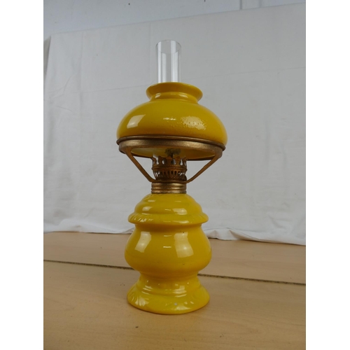 155 - A small yellow ceramic oil lamp.