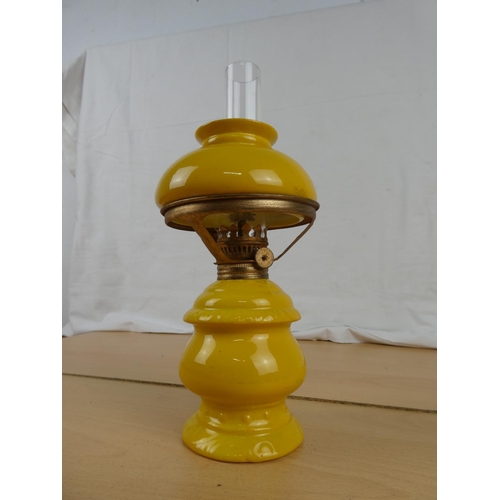 155 - A small yellow ceramic oil lamp.