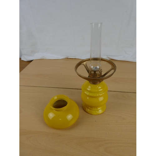 155 - A small yellow ceramic oil lamp.