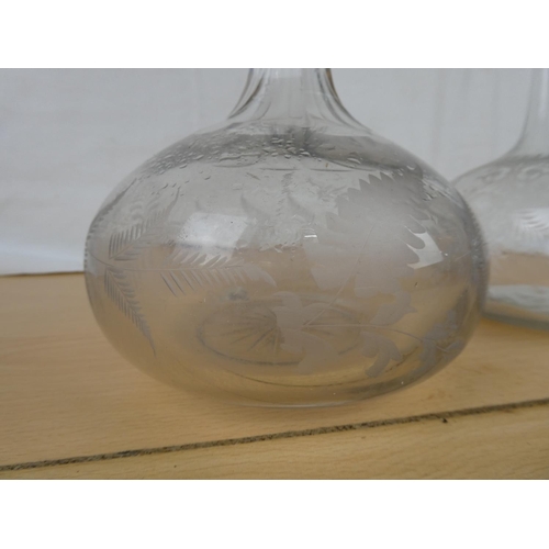 156 - Two antique glass decanters with etched design.