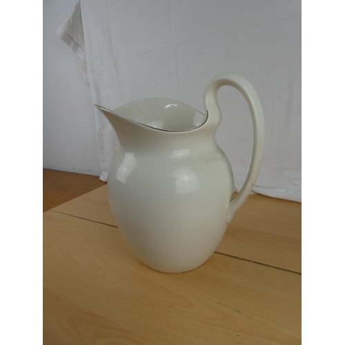 162 - An antique water jug. Approx 29cm.