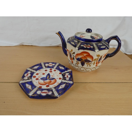 166 - An antique teapot and stand.