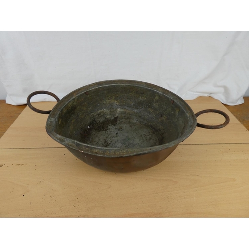 186 - An antique two handled copper bowl.