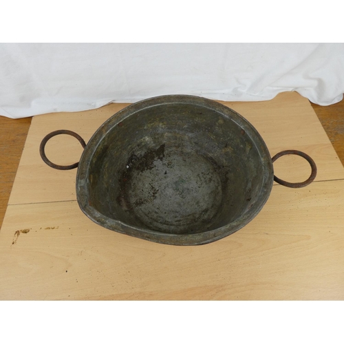 186 - An antique two handled copper bowl.