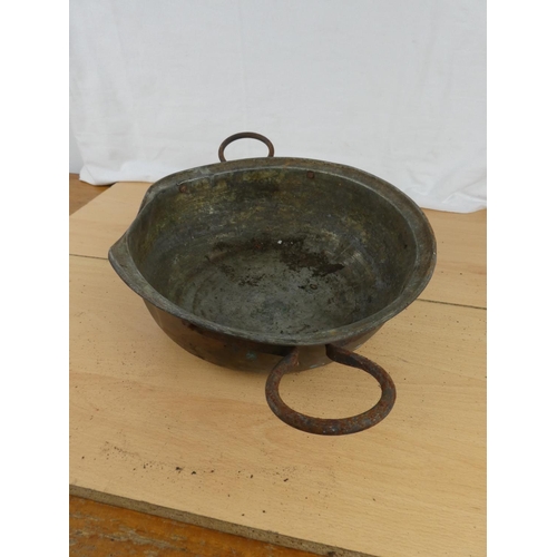 186 - An antique two handled copper bowl.