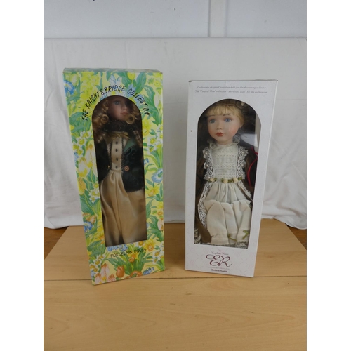 191 - Two boxed porcelain dolls.