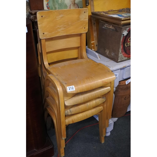 212 - A set of four pine child's stacking chairs. Approx 64cm.