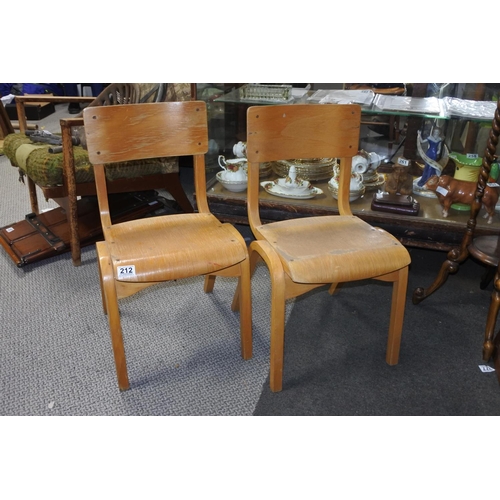 212 - A set of four pine child's stacking chairs. Approx 64cm.