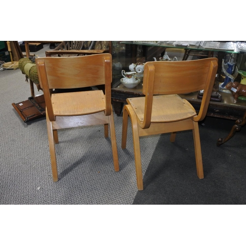 212 - A set of four pine child's stacking chairs. Approx 64cm.