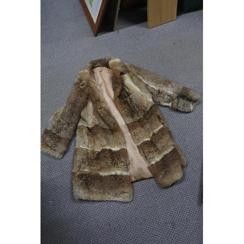 219 - A vintage fur coat.