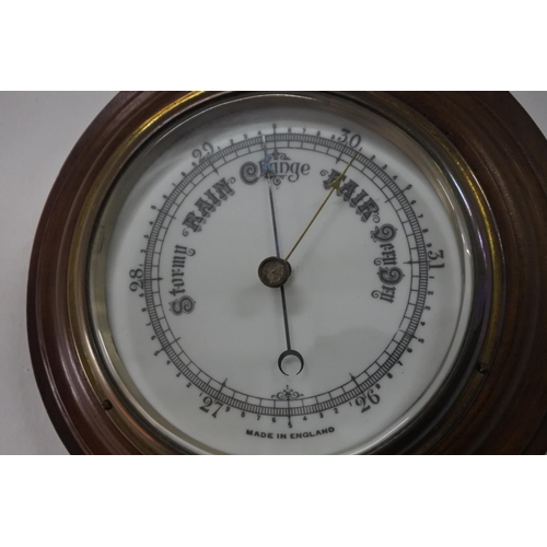 230 - An antique mahogany barometer with porcelain dial.