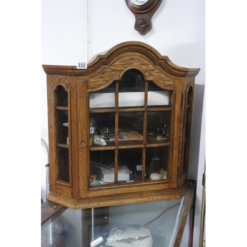 232 - A small oak wall hanging corner cabinet. Approx 69x70x46cm.