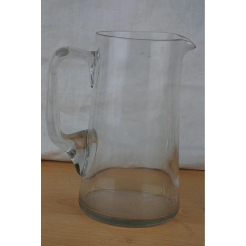 268 - A vintage glass water jug and three glasses.