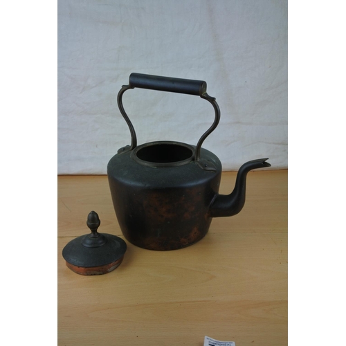 272 - An antique copper kettle.