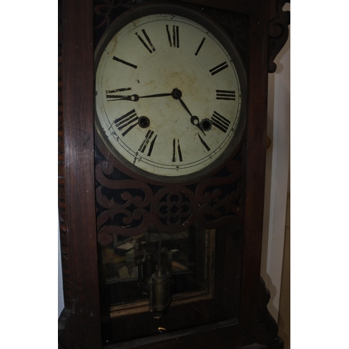 293 - An antique wall clock. Approx 84x36cm.