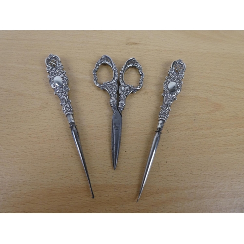 309 - Three Sterling Silver handled dressmaking tools.