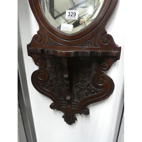 329 - A mahogany wall bracket with heart shaped mirror. Approx 66x32cm.