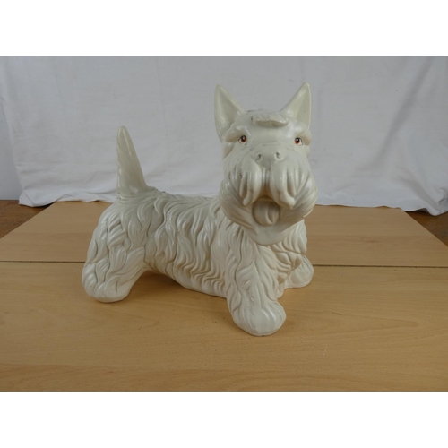 342 - A large clay pottery Scottish terrier. Approx 24x26cm.