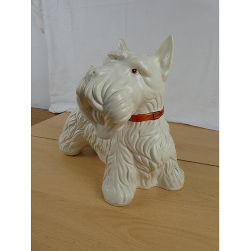 342 - A large clay pottery Scottish terrier. Approx 24x26cm.