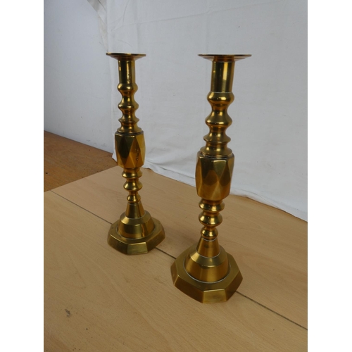 347 - A stunning pair of brass candlesticks.