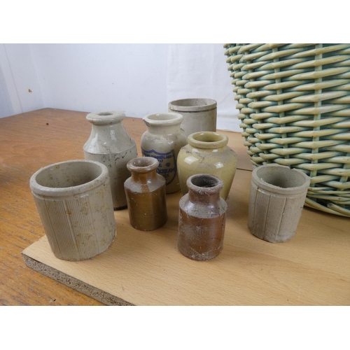 363 - A large wicker shopping basket and a collection of stoneware jars and glass bottles.