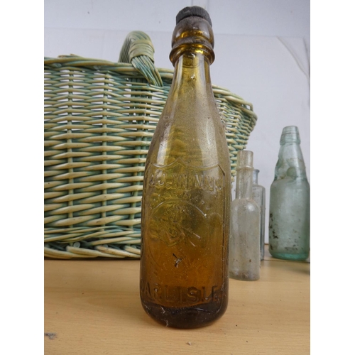 363 - A large wicker shopping basket and a collection of stoneware jars and glass bottles.