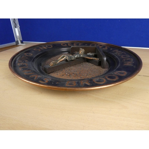 377 - A large copper religious charger. Approx 35cm.